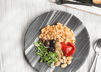 Romesco beans with roasted vegetables, olives and almonds