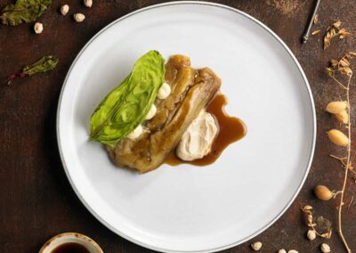 Chickpea demiglace with smoked aubergine, hummus and chard paper